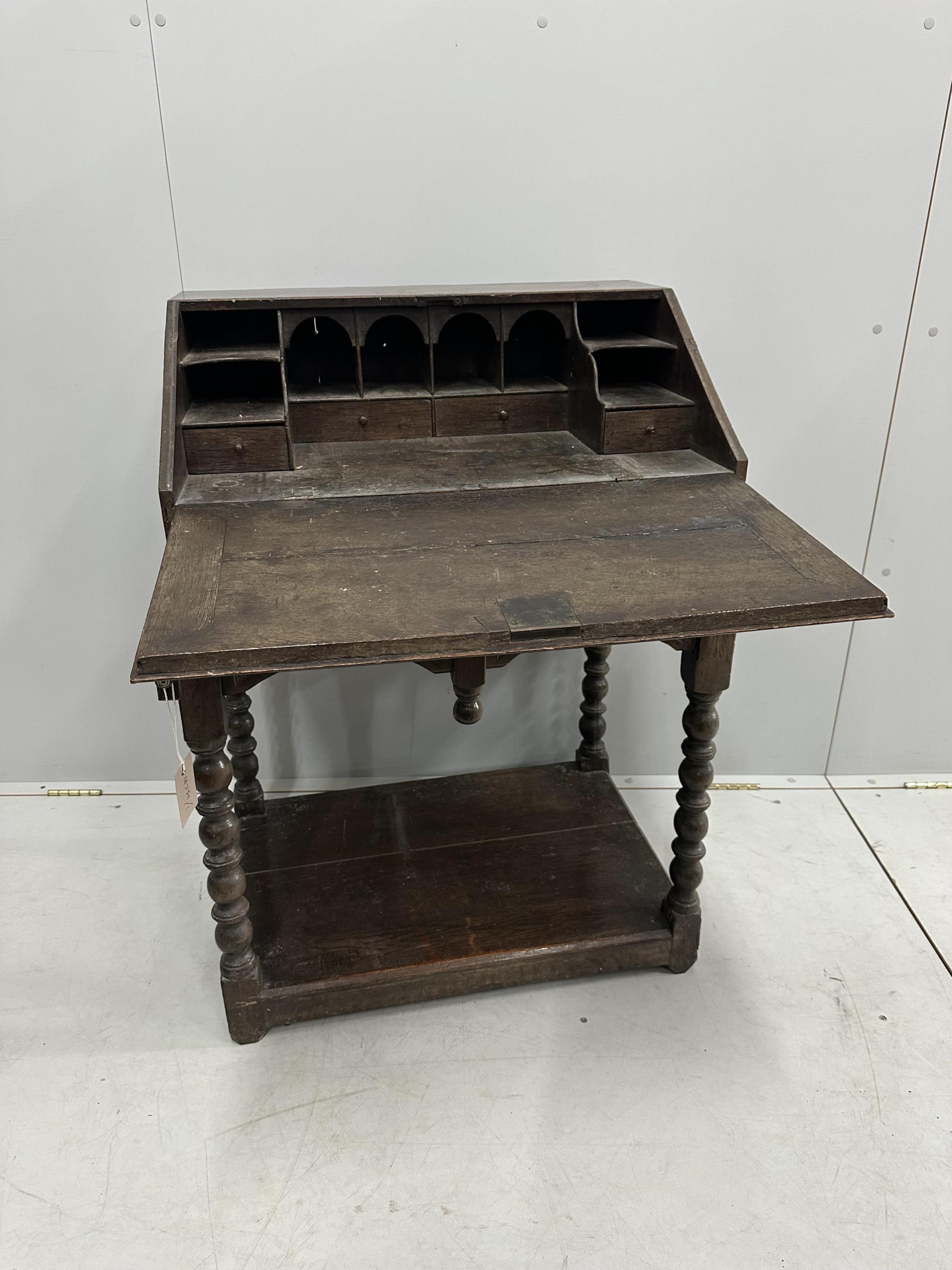 A carved oak bureau, width 68cm, depth 48cm, height 97cm